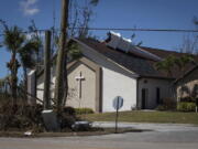 The steeple lays on its side atop Southwest Baptist Church in Fort Myers, Fla., on Sunday, Oct. 2, 2022. The church sustained heavy wind and flooding damage during Hurricane Ian as parishioners took refuge in the sanctuary.