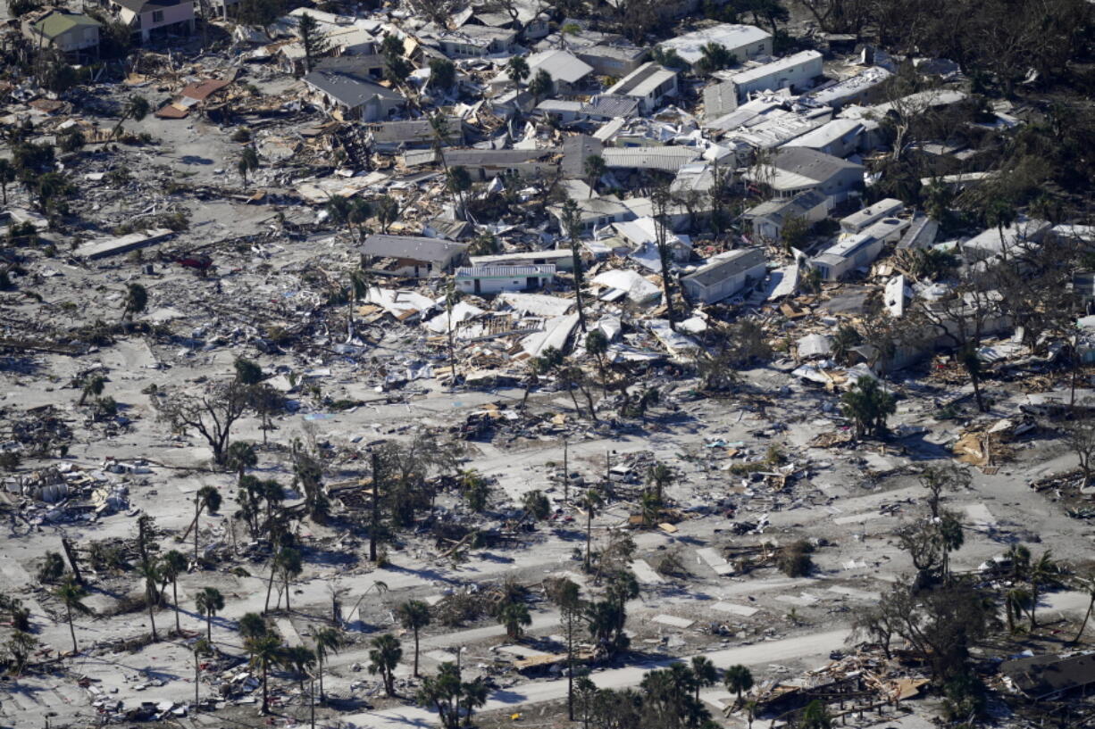 FILE - In a flight provided by mediccorps.org, debris from Hurricane Ian covers Estero Island in Fort Myers Beach, Fla., Sept. 30, 2022. Hurricane Ian confounded one key computer forecast model, creating challenges for forecasters and Florida residents.