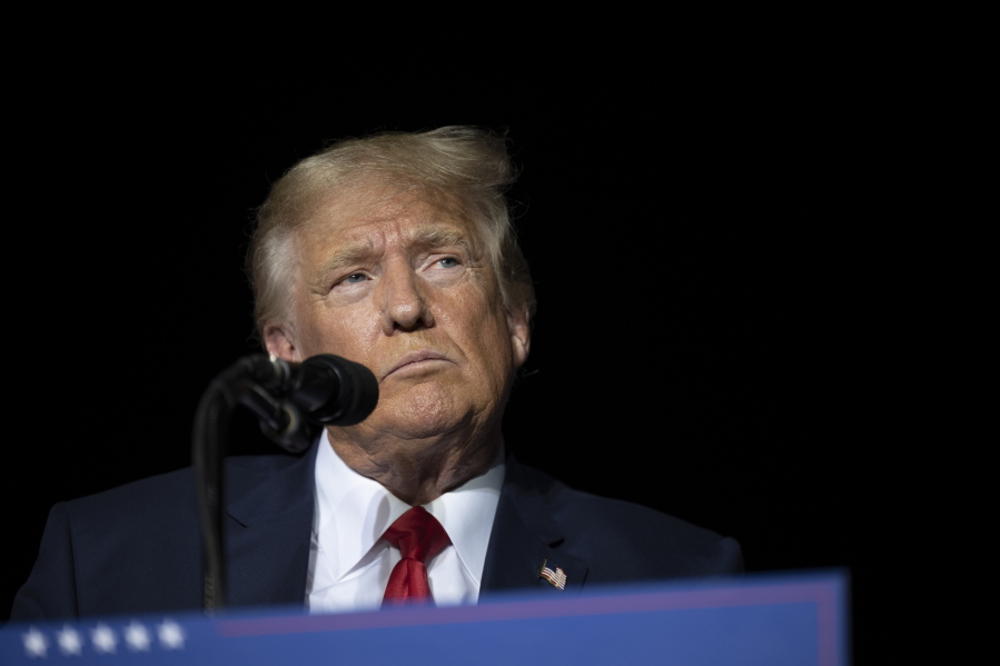 FILE - Former President Donald Trump pauses while speaking at a rally at the Minden Tahoe Airport in Minden, Nev., on Oct. 8, 2022. Trump is lashing out at the judge handling the New York attorney general's fraud lawsuit against him and his company, calling him "vicious, biased, and mean" in a social media post just days before the case's first court hearing. (AP Photo/Jos?