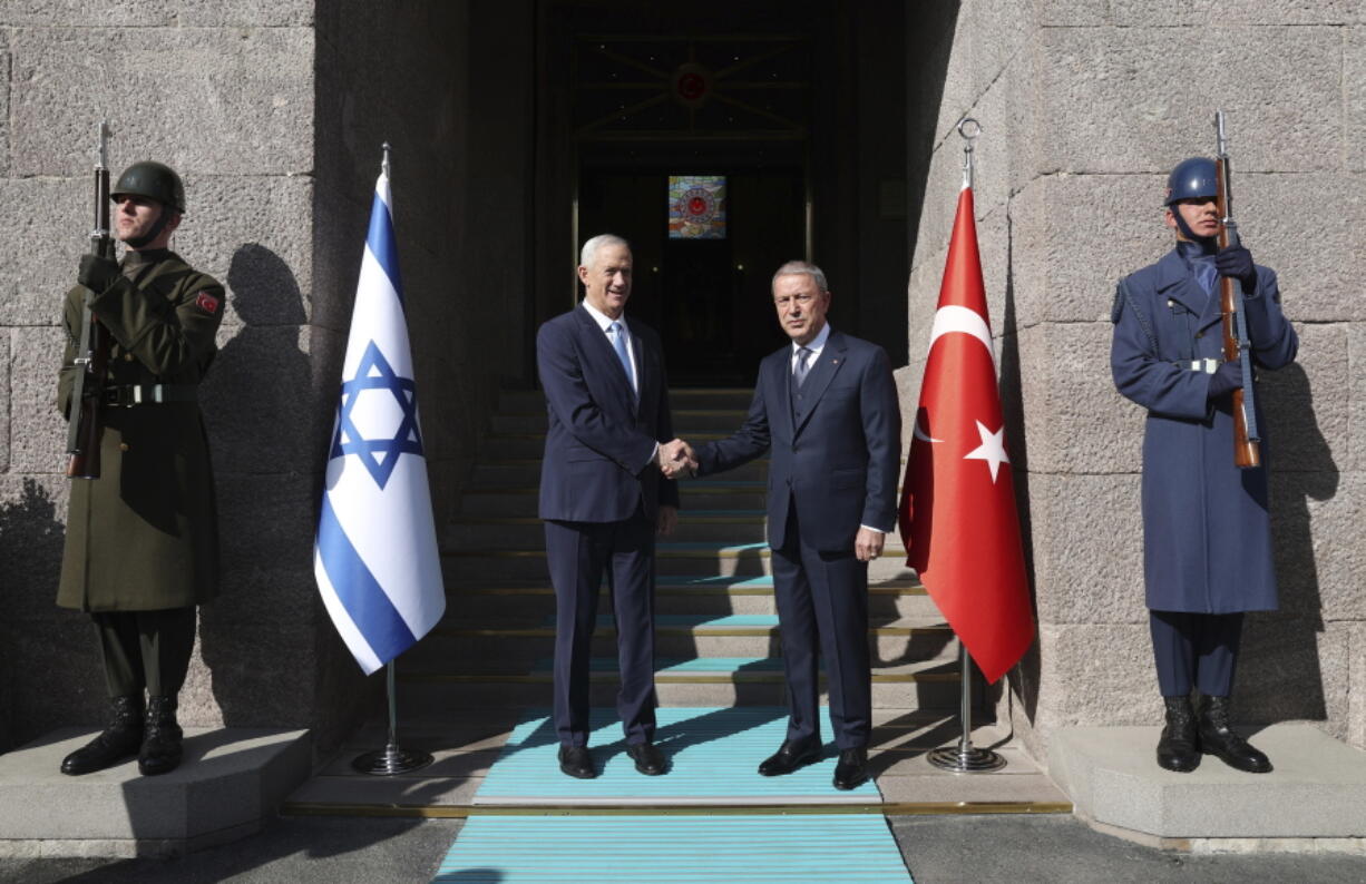 In this handout photo provided by the Turkish Defense Ministry, Turkish Defense Minister Hulusi Akar, right, and Israel's Defense Minister Benny Gantz shake hands during a welcome ceremony in Ankara, Turkey, Thursday, Oct. 27, 2022.