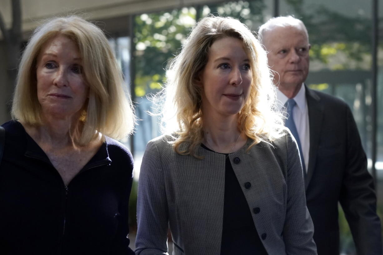 FILE - Former Theranos CEO Elizabeth Holmes, center, her mother, Noel Holmes, left, and father, Christian Holmes IV, arrive at federal court in San Jose, Calif., on Sept. 1, 2022. On Monday, Oct.