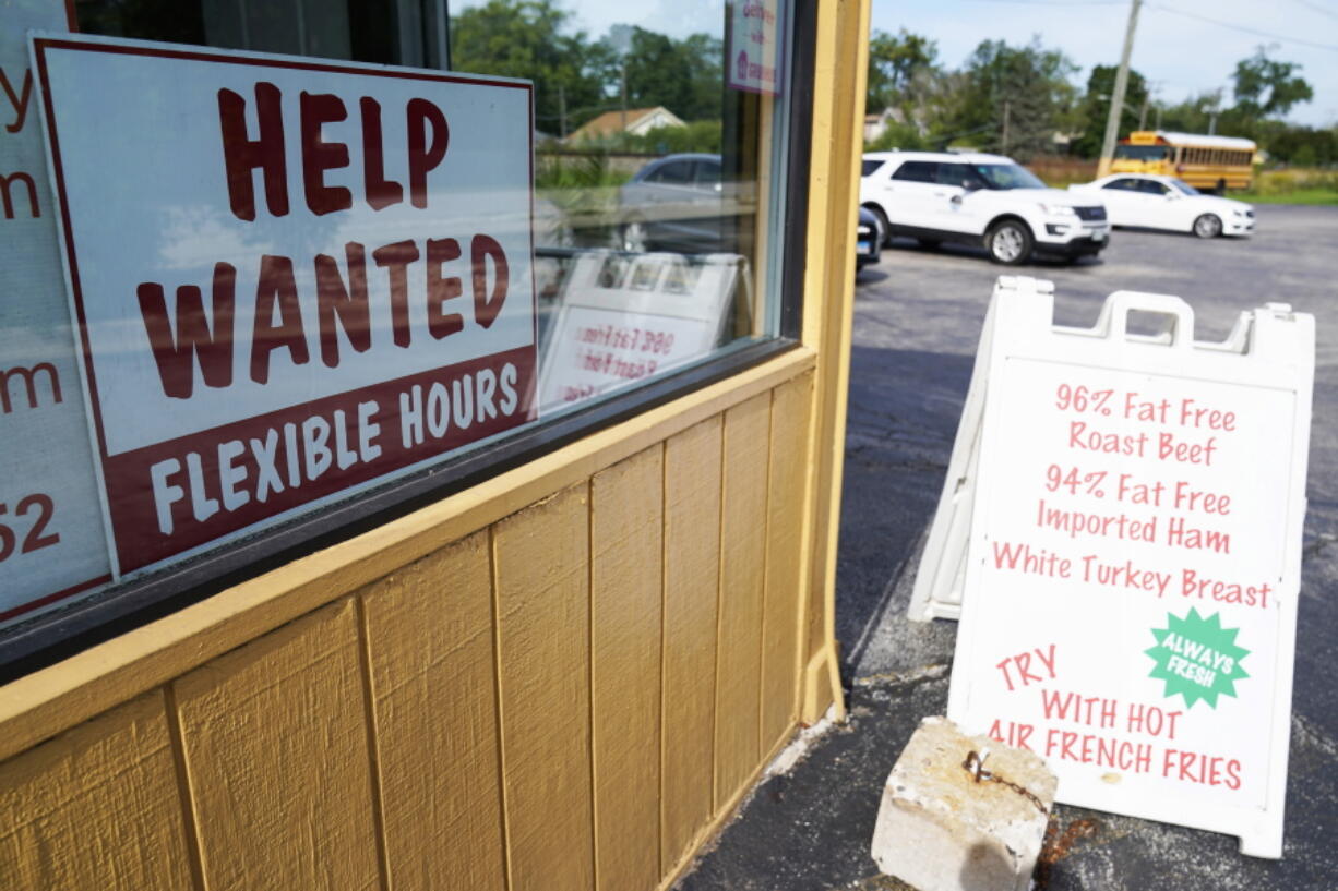 Help wanted sign is displayed in Deerfield, Ill., Wednesday, Sept. 21, 2022.  More Americans filed for unemployment benefits last week, but the labor market remains strong even in the face of persistent inflation and a slowing overall U.S. economy. Jobless claims for the week ending Oct. 1 rose by 29,000 to 219,000, the Labor Department reported Thursday, Oct. 6. (AP Photo/Nam Y.