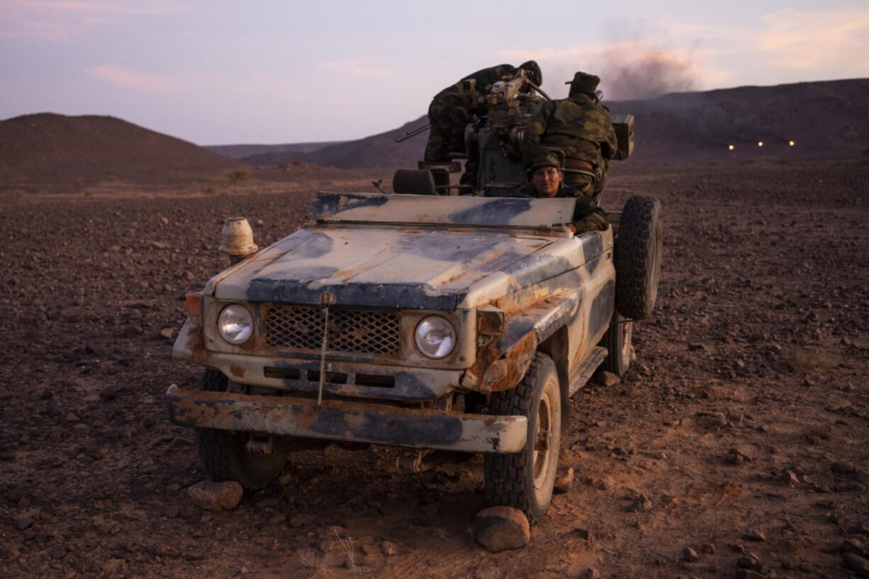 FILE - Polisario Front soldiers during a shooting exercise near Mehaires, Western Sahara on Oct. 13, 2021. The U.N. Security Council called for a revival of U.N-led negotiations on the disputed Western Sahara in a resolution adopted Thursday, Oct. 27, 2022 that expressed "deep concern" at the breakdown of the 1991 cease-fire between Morocco and the pro-independence Polisario Front whose decades-old dispute shows no sign of ending.