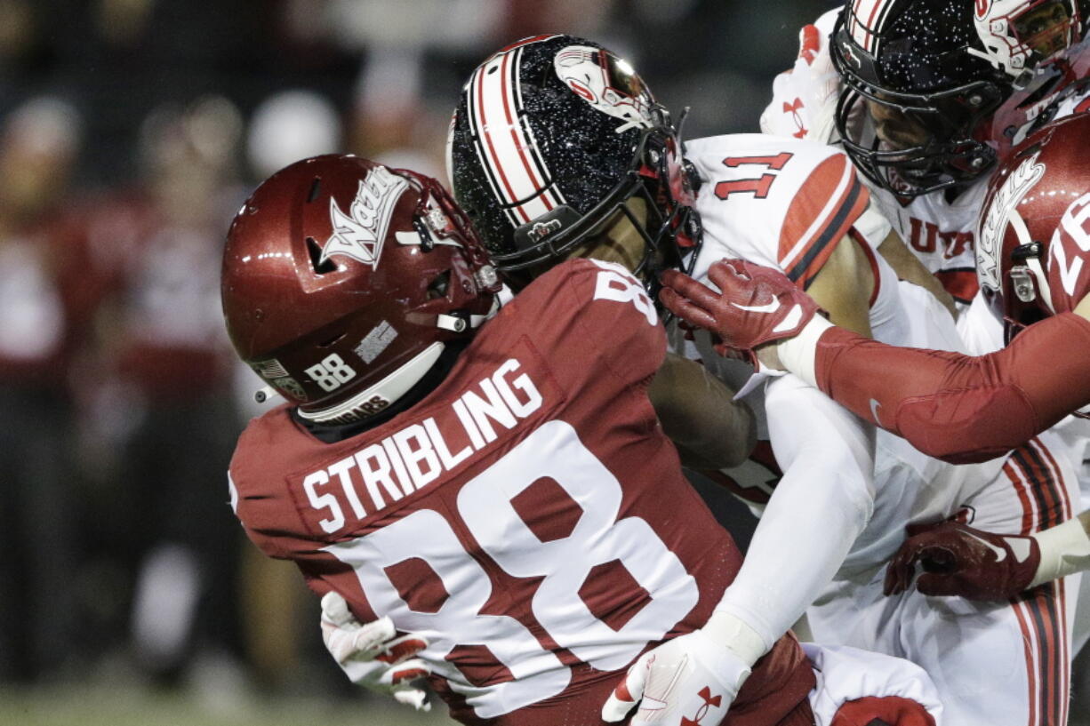 Utah safety R.J. Hubert (11) tackles Washington State wide receiver De'Zhaun Stribling (88) during the first half of an NCAA college football game, Thursday, Oct. 27, 2022, in Pullman, Wash.