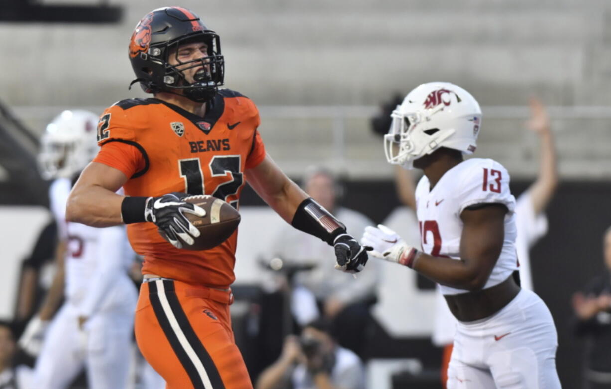 Oregon State's Jack Colletto celebrates in front of Washington State defensive back Jordan Lee after his touchdown during the first half of an NCAA college football game Saturday, Oct. 15, 2022, in Corvallis, Ore.