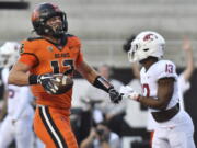 Oregon State's Jack Colletto celebrates in front of Washington State defensive back Jordan Lee after his touchdown during the first half of an NCAA college football game Saturday, Oct. 15, 2022, in Corvallis, Ore.