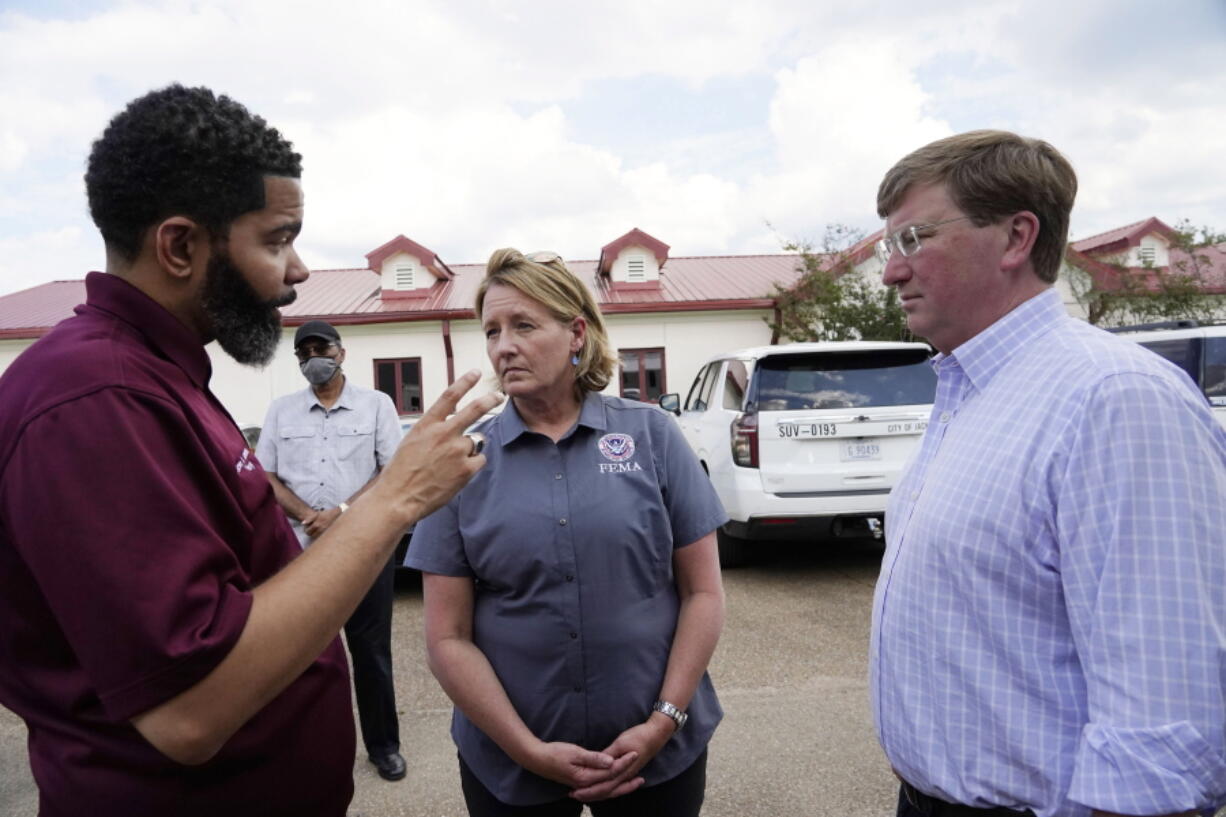 FILE - Deanne Criswell, administrator of the Federal Emergency Management Agency (FEMA), center, and Mississippi Gov. Tate Reeves, right, confer with Jackson Mayor Chokwe Antar Lumumba following a tour the City of Jackson's O.B. Curtis Water Treatment Facility in Ridgeland, Miss., Sept. 2, 2022. Jackson's water system partially failed following flooding and heavy rainfall that exacerbated longstanding problems in one of two water-treatment plants. On Friday, Oct. 28, Reeves extended the State of Emergency regarding Jackson's water system until Nov. 22. (AP Photo/Rogelio V.