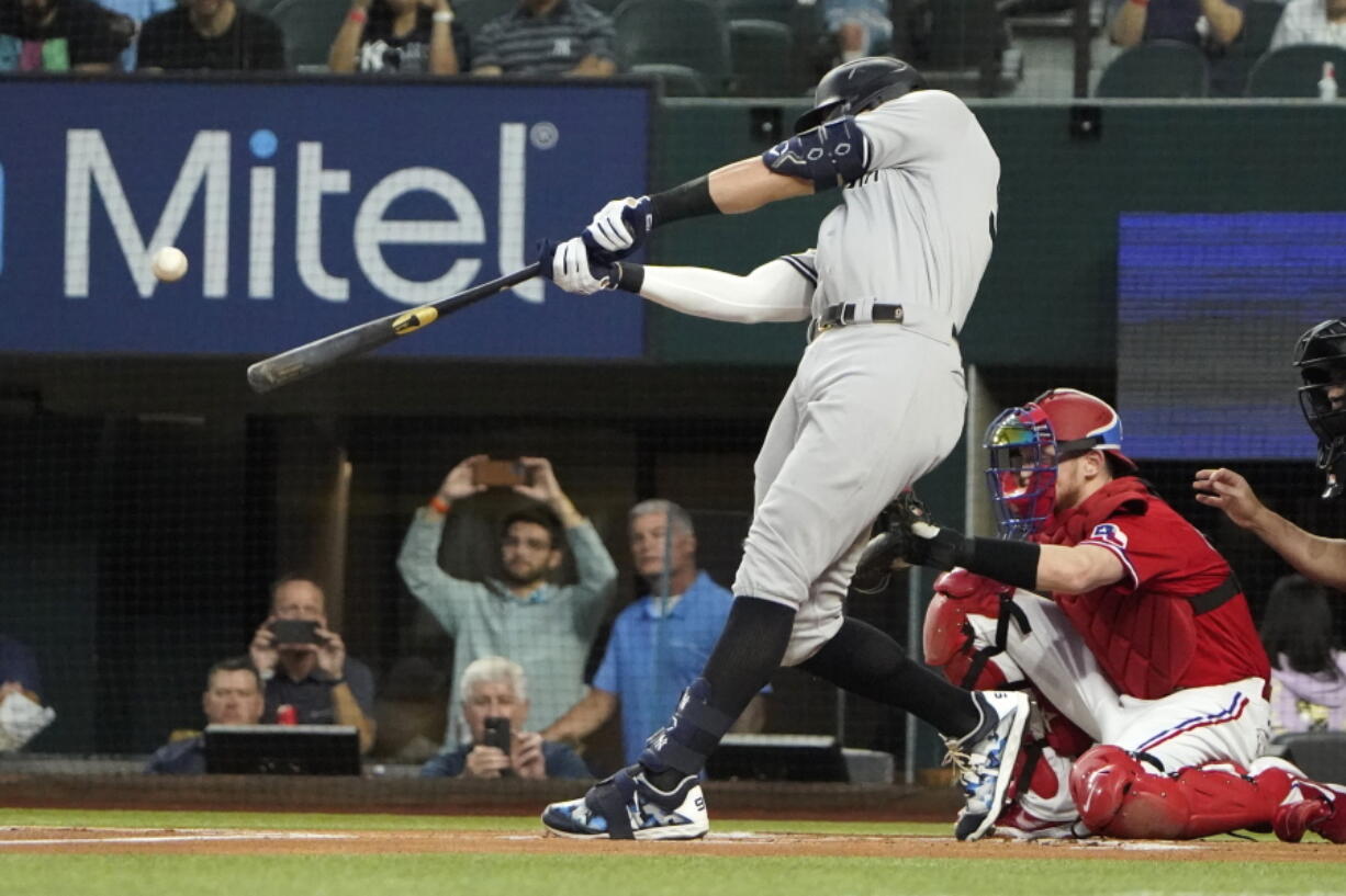 New York Yankees' Aaron Judge hits a solo home run, his 62nd of the season, during the first inning in the second baseball game of a doubleheader against the Texas Rangers in Arlington, Texas, Tuesday, Oct. 4, 2022. With the home run, Judge set the AL record for home runs in a season, passing Roger Maris.