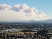 A large plume of smoke billows from the Nakia Creek Fire near Larch Mountain in east Clark County in this view taken at about 11:30 a.m. Fire activity increased significantly Sunday morning due to unseasonably hot, dry and windy conditions.