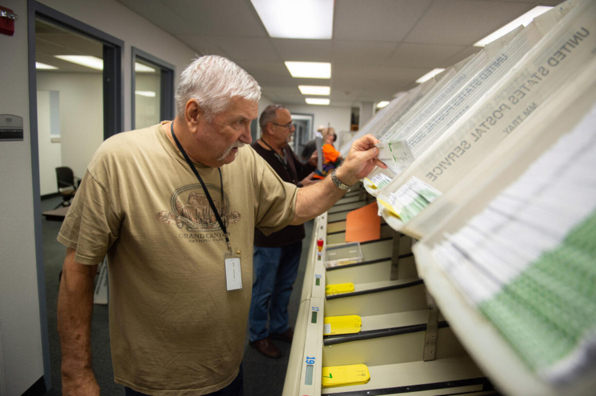 Clark County Elections Office ballot processing is underway as Election Day approaches. Gregg Peck, an inspection board worker, sorts ballots into their districts.