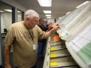 Clark County Elections Office ballot processing is underway as Election Day approaches. Gregg Peck, an inspection board worker, sorts ballots into their districts.