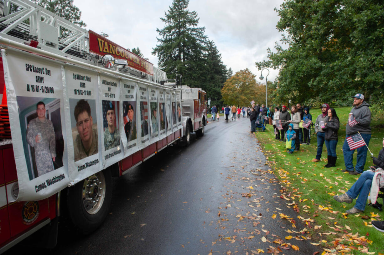 Vancouver Fire Truck No. 1 displays photos of local veterans killed in action on Saturday during the Lough Legacy Veterans Parade along Evergreen Boulevard in Vancouver. At top, the Oregon Volunteer Infantry marches in the parade.