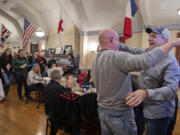 Campaign manager Scott Wilcox, second from right, embraces John Horch, right, to celebrate Horch's Tuesday night lead in the Clark County sheriff's race at an election night gathering at the Red Cross Building at the Fort Vancouver National Site.