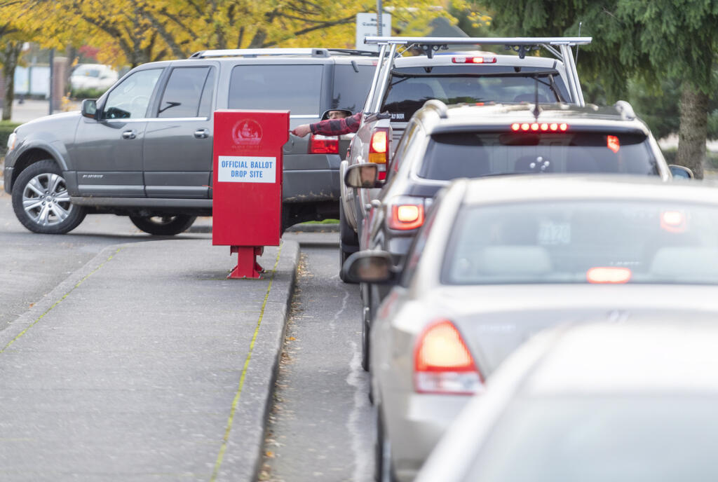 Voters drop ballots Tuesday afternoon at the Fisher's Landing Transit Center.