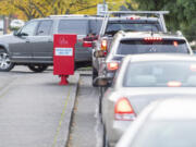 Voters drop ballots Tuesday afternoon at the Fisher's Landing Transit Center.