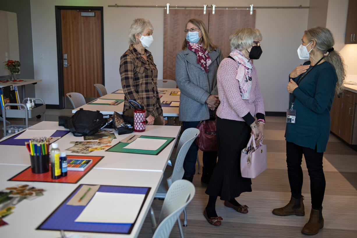 Karen Beall of Ridgefield, left, chats in the art therapy room with Sue Hammann of Vancouver as Catherine Cotton, also of Vancouver, and art therapist Margaret Hartsook talk during a tour of the new Cancer Healing Center at Legacy Salmon Creek Medical Center.