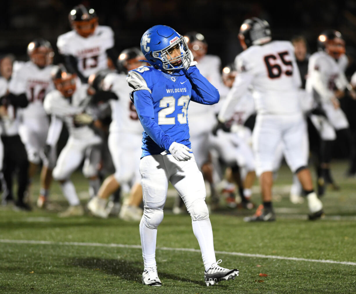 La Center junior Jalen Ward walks off the field as Cashmere celebrates behind him Friday after the 1A state playoff game at Woodland High School.