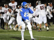 La Center junior Jalen Ward walks off the field as Cashmere celebrates behind him Friday after the 1A state playoff game at Woodland High School.