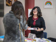 Teen Talk volunteer Stephanie Zonker talks to a parent during a teen mental health event at Prairie High School.