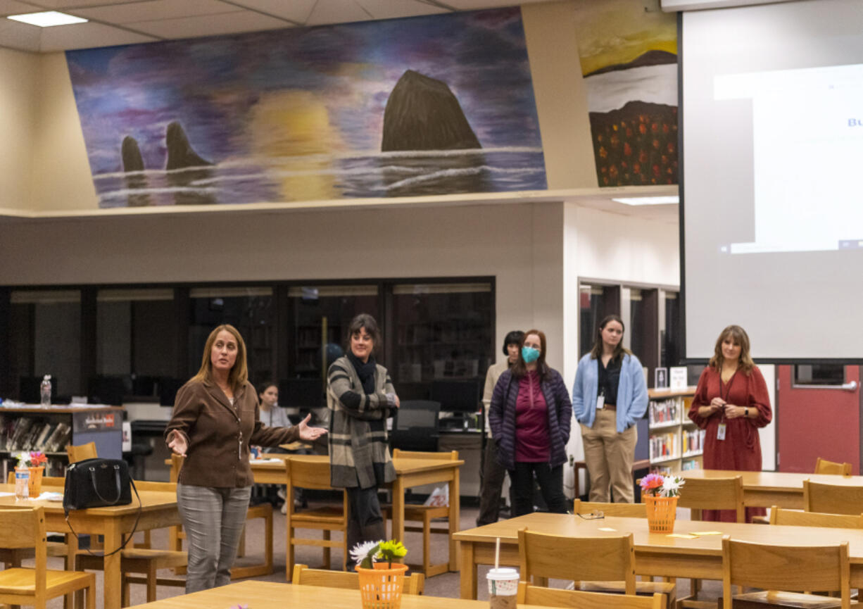 Prairie High School counselor Marla Caesar, left, performs an exercise with parents and faculty Wednesday during a teen mental health night at the Prairie High School library.