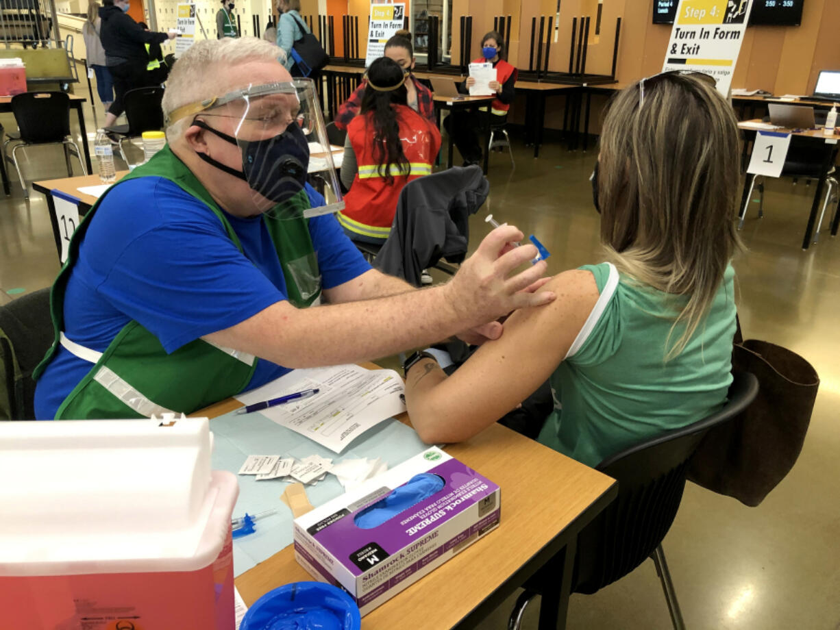 Jack Stump administering a vaccine during a Clark County Public Health vaccination clinic at Woodland High School in March 2021.