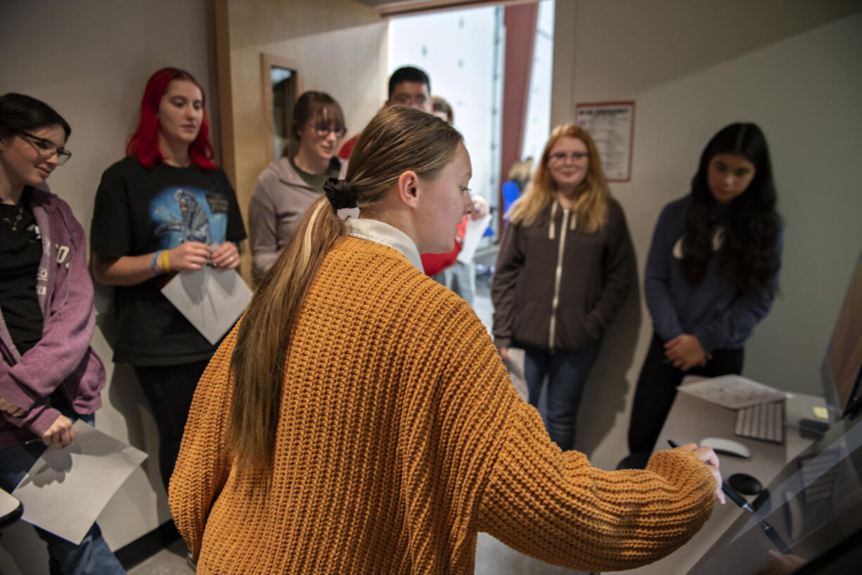 Sarah Hubbard, 16, center, who is studying digital design through Ridgefield High School's Center for Advanced Professional Studies program, demonstrates how to use a drawing tablet for tour visitors Wednesday afternoon. "Students really take ownership of their work here," said Jared Hundley, the CAPS program director. "There's incentive for them.