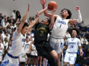 Evergreen freshman Dez Daniel, center, shoots the ball under pressure from Mountain View senior Isaiah Vargas, right, and senior Peter Nguyen on Tuesday, Nov. 29, 2022, during the Thunder’s 74-60 win against Evergreen at Mountain View High School.