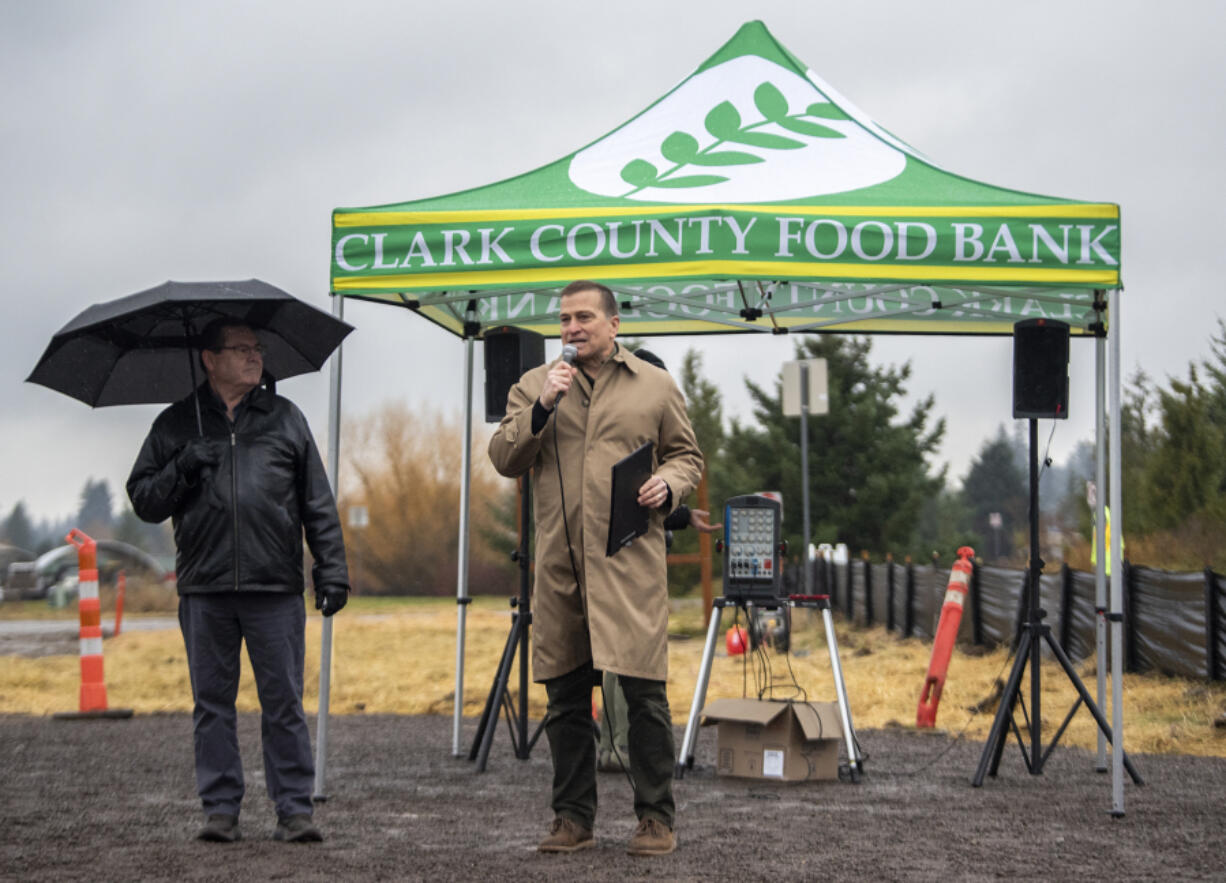 Clark County Food Bank President Alan Hamilton, center, and Board Chair Elson Strahan, left, stand and deliver speeches during a groundbreaking ceremony for the Clark County Food Bank's new Vision Center.