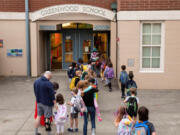 Students enter Greenwood Elementary on the first day of school on Wednesday, Sept. 14, 2022.