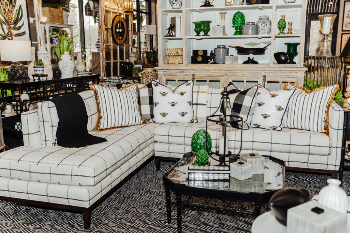 A beautiful sectional featuring bee-themed pillows.