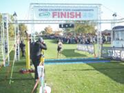 Alexis Leone of Seton Catholic crosses the finish line to repeat as Class 1A girls champion at the WIAA State Cross Country Championship on Saturday Nov. 5, 2022 in Pasco.