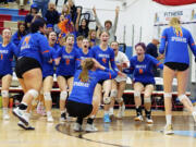 The Ridgefield Spudders celebrate match point, winning the 2A District 4 volleyball championship in five sets against rival Columbia River on Saturday, Nov. 12, 2022, at Mark Morris High School in Longview.