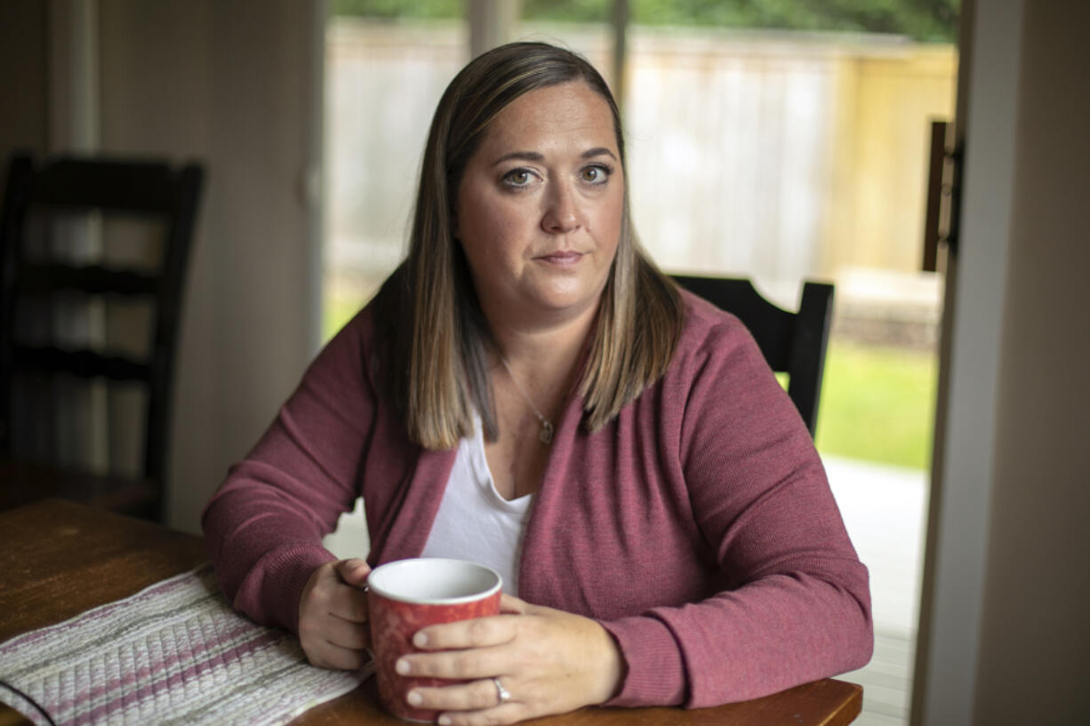 Marie Riley, 42, sits in her dining room with a cup of tea Tuesday, Oct. 25, 2022, at her family???s home in North Bend, Washington. Riley was born with tetralogy of fallot, a rare congenital heart condition that has required multiple open-heart surgeries during her lifetime.