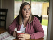 Marie Riley, 42, sits in her dining room with a cup of tea Tuesday, Oct. 25, 2022, at her family???s home in North Bend, Washington. Riley was born with tetralogy of fallot, a rare congenital heart condition that has required multiple open-heart surgeries during her lifetime.