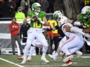 Oregon quarterback Bo Nix (10) looks to pass against Utah during the second half of an NCAA college football game Saturday, Nov. 19, 2022, in Eugene, Ore.