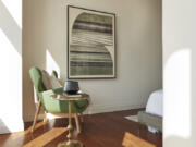 A green upholstery piece is paired with artwork to add an inspirational color moment.