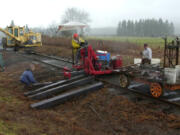 The Chelatchie Prairie Railroad is receiving $4.7 million from Washington transportation funds for the railroad's rehabilitation. In this 2002 photo, BYCX Railroad volunteers replace rotted ties on the north end of the line.