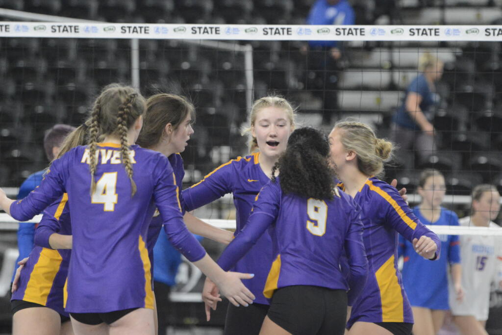 Sophie Worden, center, and her Columbia River teammates gather during the Class 2A volleyball state championship match against Ridgefield on Saturday, Nov. 19, 2022, in Yakima.