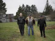 Veterans Ron Powers, from left, Ron Fryer and Mike Stacey walk on property for a proposed micro-home village for female veterans off Northeast St. James Road in December 2016.