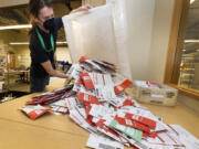 Election worker Patrick Schmeichel prepares to process ballots that just arrived from a ballot drop-box on Election Day at the King County Elections headquarters, Tuesday, Nov. 8, 2022, in Renton, Wash.