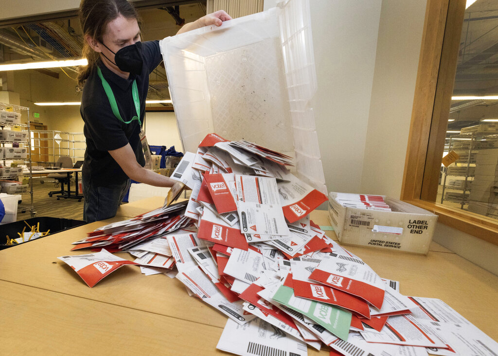 Election worker Patrick Schmeichel prepares to process ballots that just arrived from a ballot drop-box on Election Day at the King County Elections headquarters, Tuesday, Nov. 8, 2022, in Renton, Wash.