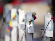 Roses adorn crosses at a makeshift memorial for the victims of a mass shooting at Club Q, gay nightclub, Wednesday, Nov. 23, 2022, in Colorado Springs, Colo.