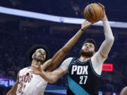 Portland Trail Blazers center Jusuf Nurkic (27) grabs a rebound against Cleveland Cavaliers center Jarrett Allen (31) during the first half of an NBA basketball game, Wednesday, Nov. 23, 2022, in Cleveland.