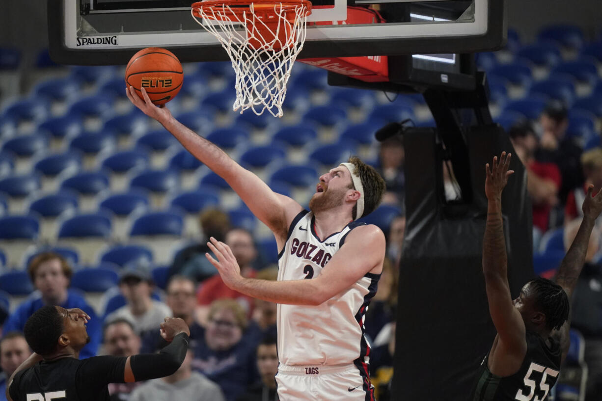 Gonzaga forward Drew Timme (2) goes to the basket as Portland State guard Keshaun Saunders (55) defends during the first half of an NCAA college basketball game in the Phil Knight Legacy tournament Thursday, Nov. 24, 2022, in Portland, Ore.