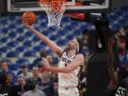 Gonzaga forward Drew Timme (2) goes to the basket as Portland State guard Keshaun Saunders (55) defends during the first half of an NCAA college basketball game in the Phil Knight Legacy tournament Thursday, Nov. 24, 2022, in Portland, Ore.