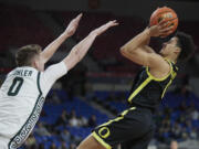 Oregon guard Will Richardson, right, shoots over Michigan State forward Jaxon Kohler during the first half of an NCAA college basketball game in the Phil Knight Invitational tournament in Portland, Ore., Friday, Nov. 25, 2022.