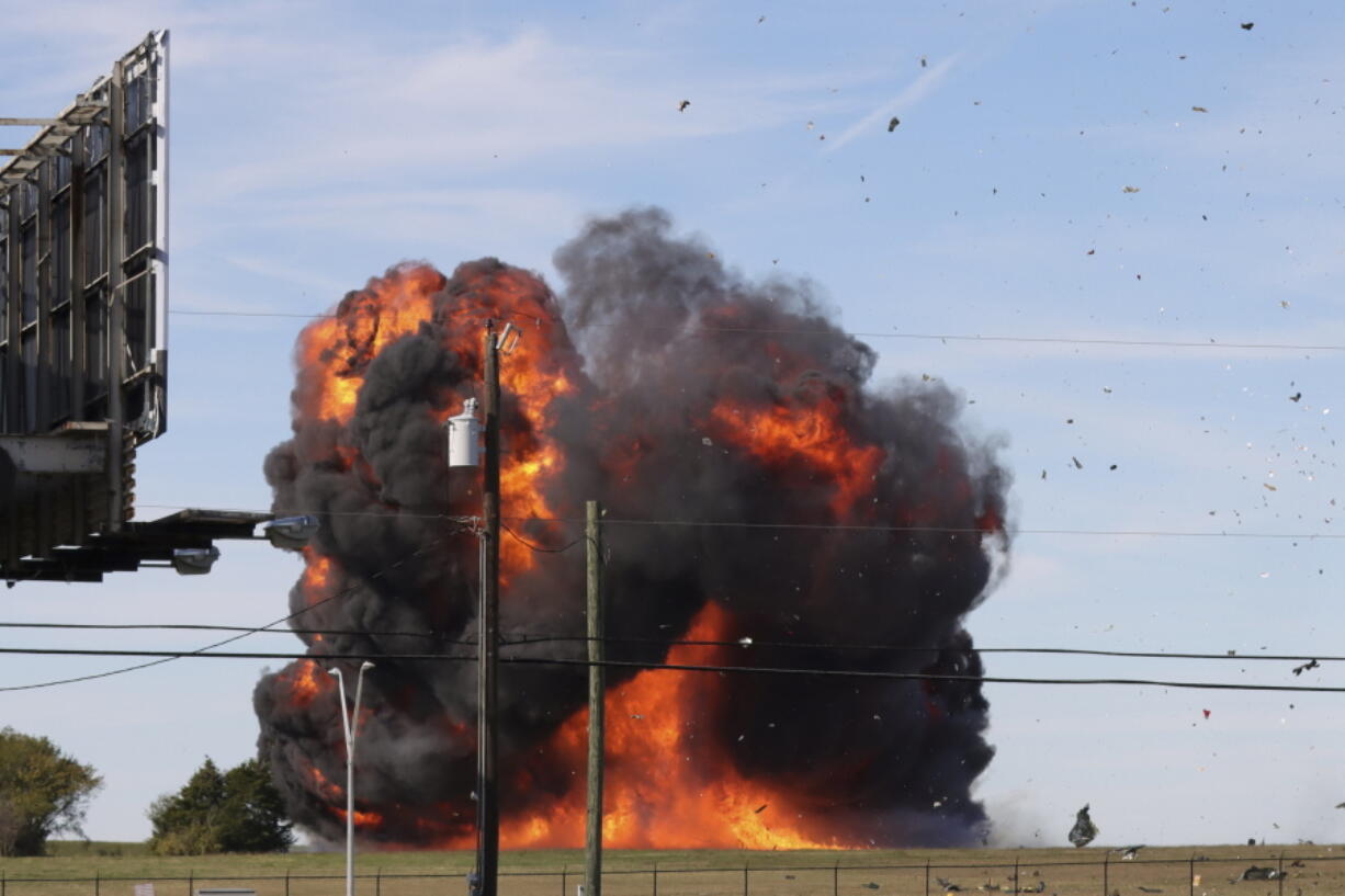 In this photo provided by Nathaniel Ross Photography, a historic military plane crashes after colliding with another plane during an airshow at Dallas Executive Airport in Dallas on Saturday, Nov. 12, 2022.
