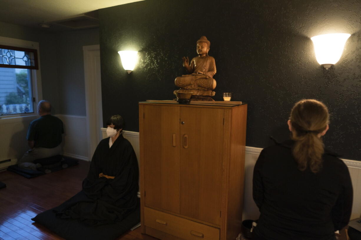 Resident priest Genmyo Jana Zeedyk, second from left, and other members of the Anchorage Zen Community meditate during a Sunday service Oct. 9 in Anchorage, Alaska. (Jae C.