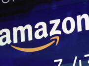 FILE - The Amazon logo is displayed on a screen at the Nasdaq MarketSite, July 27, 2018. Amazon is stepping back into virtual care with a new service that uses secure messaging to connect patients with doctors for help with nearly two dozen conditions. The retail giant said Tuesday, Nov. 15, 2022,  it will launch Amazon Clinic in 32 states to provide medication refills and care for conditions like allergies, erectile disfunction, hair loss, and urinary tract infections.