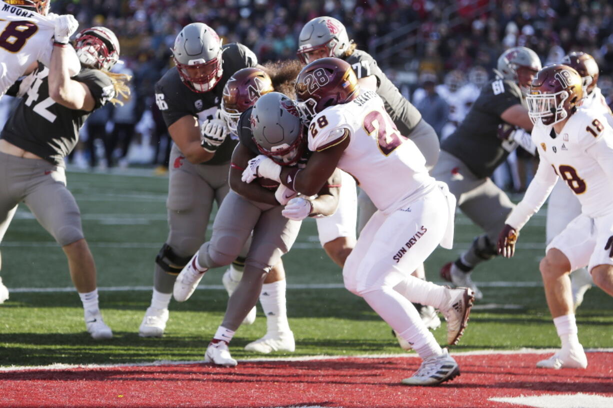 Washington State running back Nakia Watson, center left, runs in for a touchdown while defended by Arizona State linebacker Will Shaffer (28) during the first half of an NCAA college football game, Saturday, Nov. 12, 2022, in Pullman, Wash.